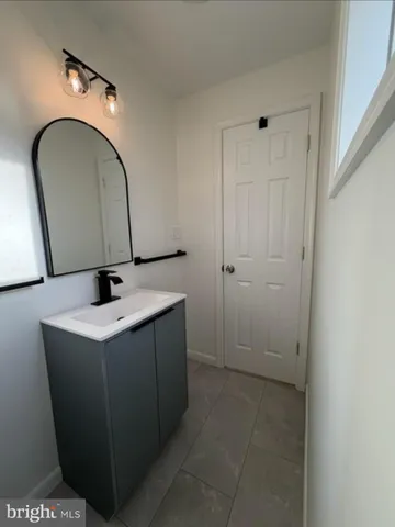 a bathroom with a sink and mirror