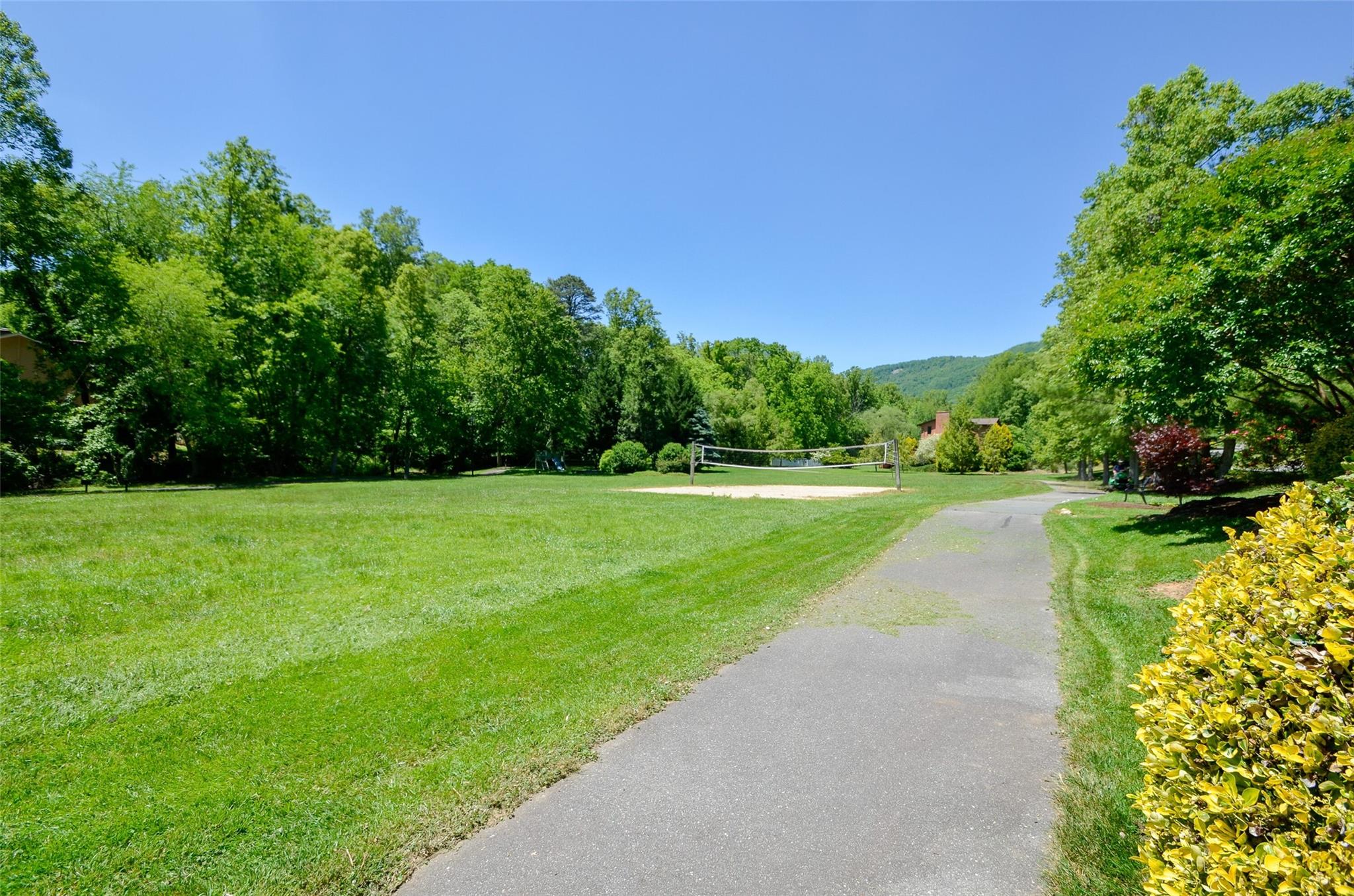 209 Riva Ridge Drive Fairview, NC 28730 - Photo 20 of 23 a view of a garden with a building in the background