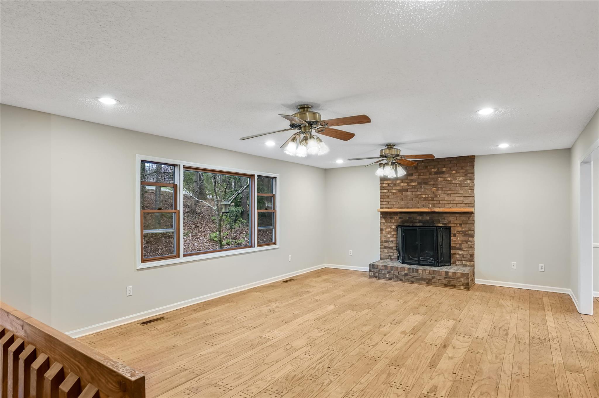 209 Riva Ridge Drive Fairview, NC 28730 - Photo 2 of 23 a view of an empty room with a window and a fireplace