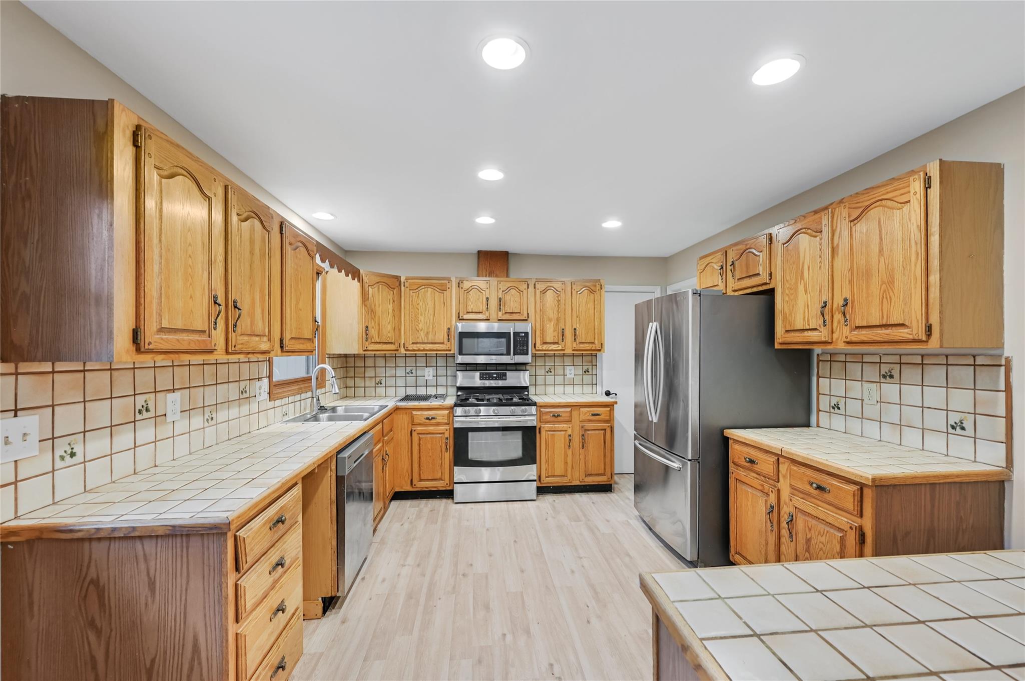 209 Riva Ridge Drive Fairview, NC 28730 - Photo 5 of 23 a kitchen with stainless steel appliances granite countertop a refrigerator a sink dishwasher a oven with white cabinets and wooden floor