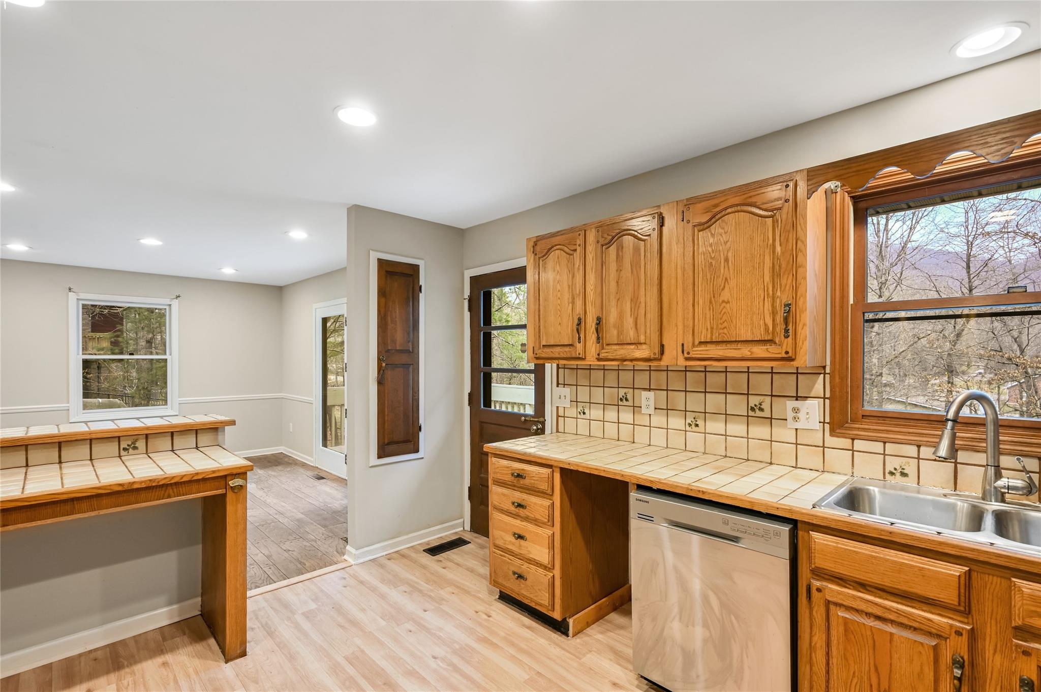 209 Riva Ridge Drive Fairview, NC 28730 - Photo 6 of 23 a view of a kitchen with a sink and wooden floor