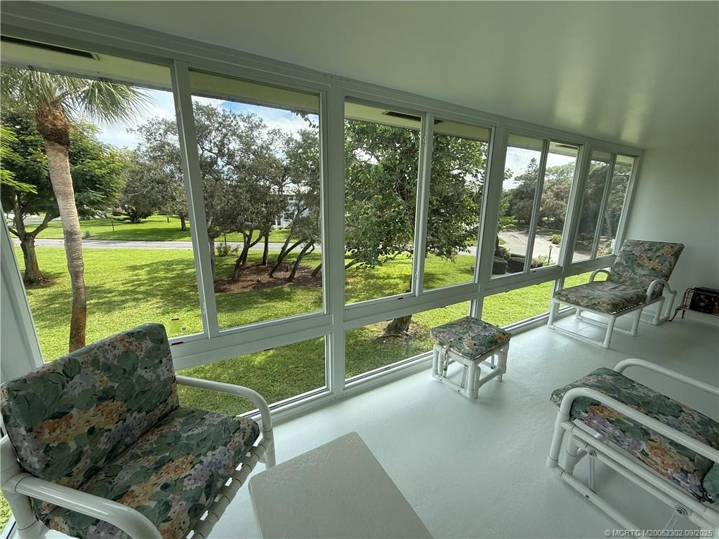 2929 Southeast Ocean Boulevard, Unit 8 Stuart, FL 34996 - Photo 12 of 22 a building outdoor space with furniture and garden view