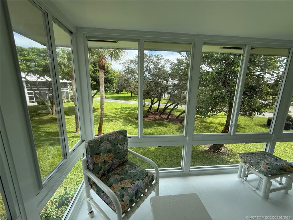 2929 Southeast Ocean Boulevard, Unit 8 Stuart, FL 34996 - Photo 13 of 22 a living room filled with furniture and garden view