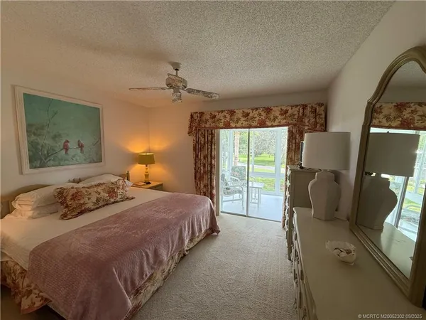 a bedroom with a bed mirror and window
