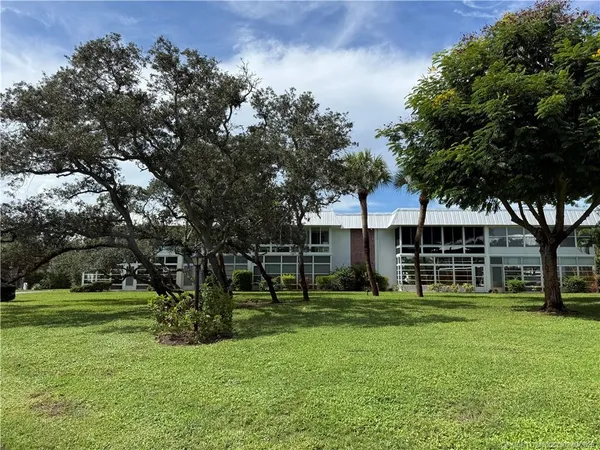 a view of a house with a tree in a park