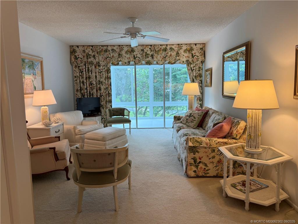 2929 Southeast Ocean Boulevard, Unit 8 Stuart, FL 34996 - Photo 2 of 22 a living room with furniture and a large window