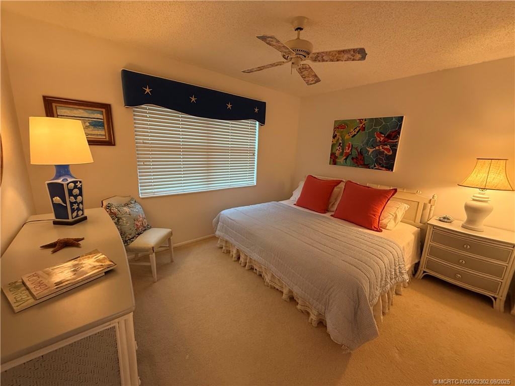 2929 Southeast Ocean Boulevard, Unit 8 Stuart, FL 34996 - Photo 4 of 22 a bedroom with a bed and a window