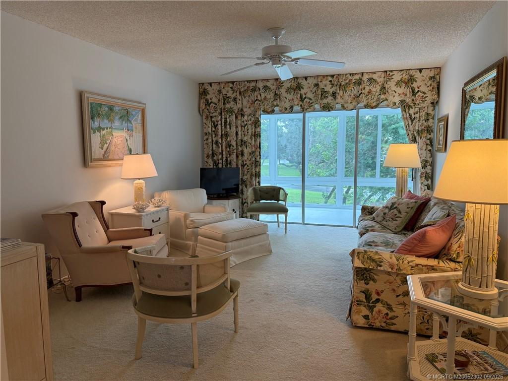 2929 Southeast Ocean Boulevard, Unit 8 Stuart, FL 34996 - Photo 9 of 22 a living room with furniture and a large window