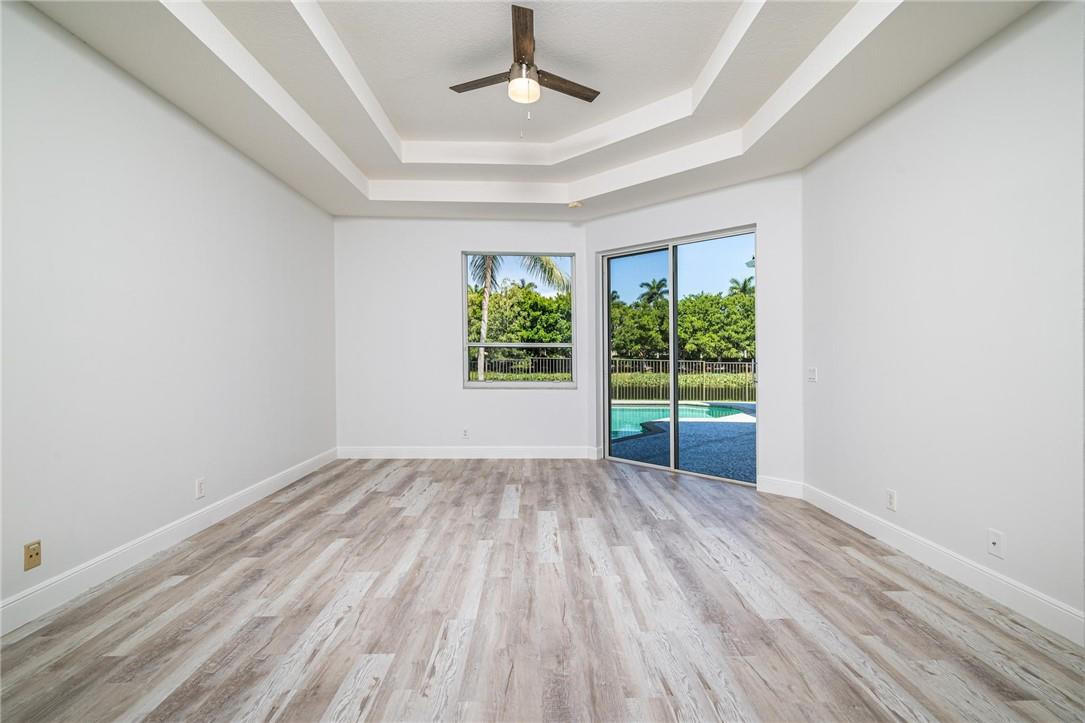 3759 Oak Ridge Circle Weston, FL 33331 - Photo 11 of 31 a view of an empty room with wooden floor and a window
