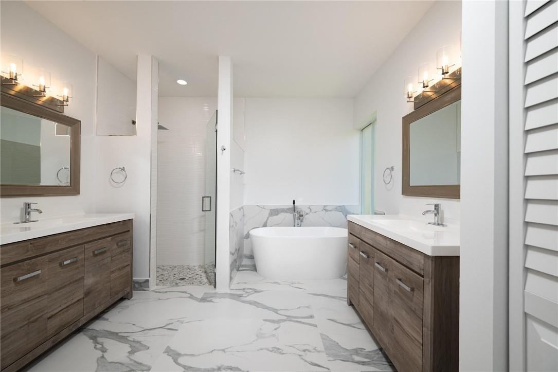 3759 Oak Ridge Circle Weston, FL 33331 - Photo 13 of 31 a spacious bathroom with a double vanity sink a mirror and a bathtub