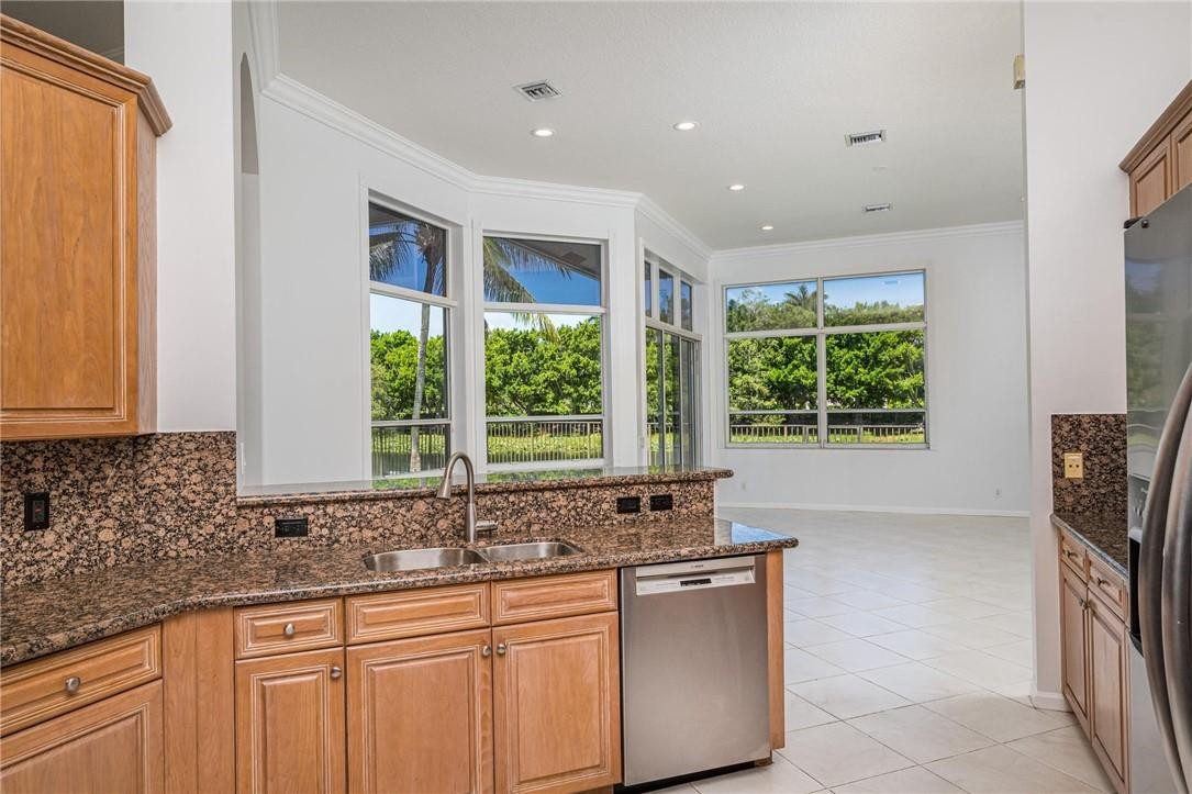 3759 Oak Ridge Circle Weston, FL 33331 - Photo 16 of 31 a kitchen with stainless steel appliances granite countertop a sink and a large window