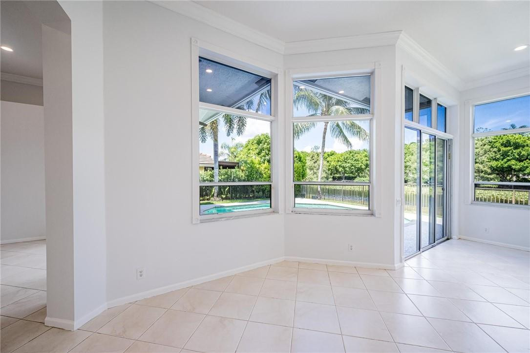 3759 Oak Ridge Circle Weston, FL 33331 - Photo 19 of 31 a view of an empty room with wooden floor and a window