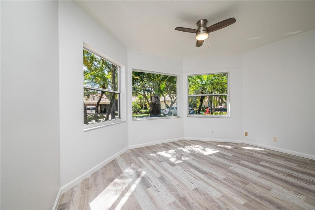 3759 Oak Ridge Circle Weston, FL 33331 - Photo 21 of 31 an empty room with windows and ceiling fan
