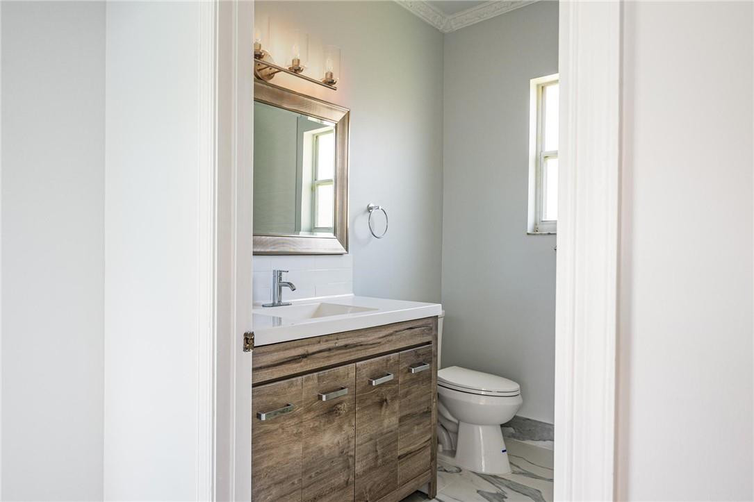 3759 Oak Ridge Circle Weston, FL 33331 - Photo 23 of 31 a bathroom with a toilet a sink and a mirror