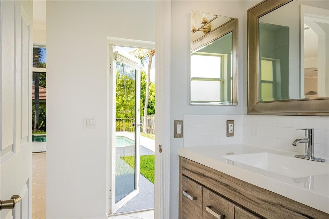 3759 Oak Ridge Circle Weston, FL 33331 - Photo 24 of 31 a bathroom with a sink and a window