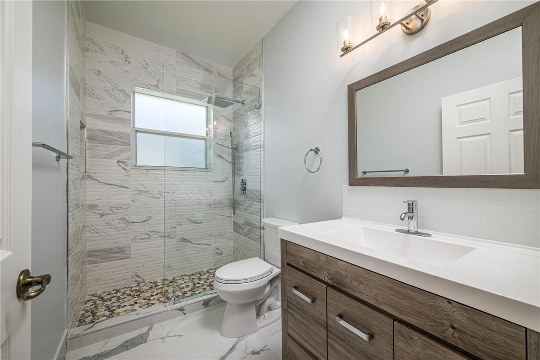 3759 Oak Ridge Circle Weston, FL 33331 - Photo 26 of 31 a bathroom with a sink a toilet and shower
