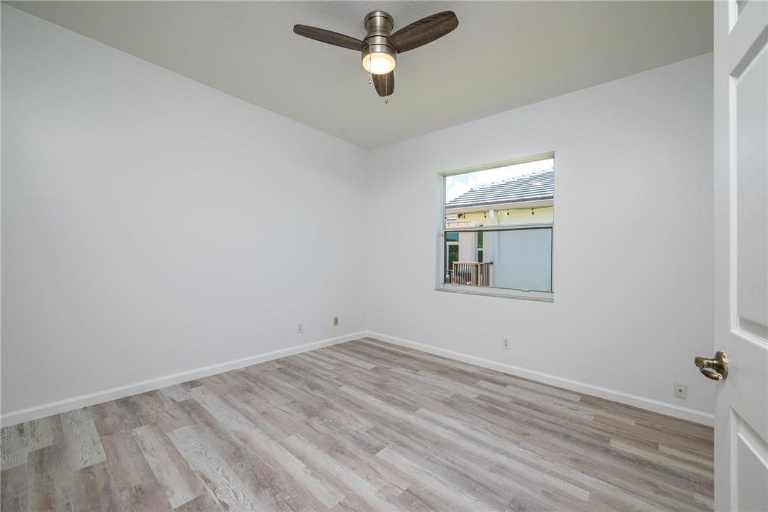 3759 Oak Ridge Circle Weston, FL 33331 - Photo 27 of 31 an empty room with a window and ceiling fan