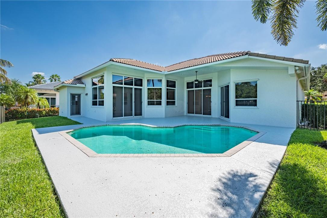 3759 Oak Ridge Circle Weston, FL 33331 - Photo 4 of 31 a front view of a house with a yard