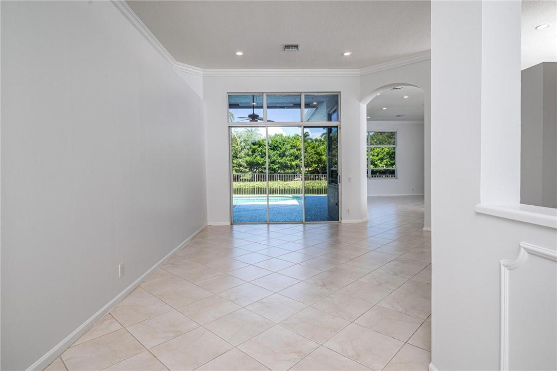 3759 Oak Ridge Circle Weston, FL 33331 - Photo 9 of 31 a view of an empty room with wooden floor and a window