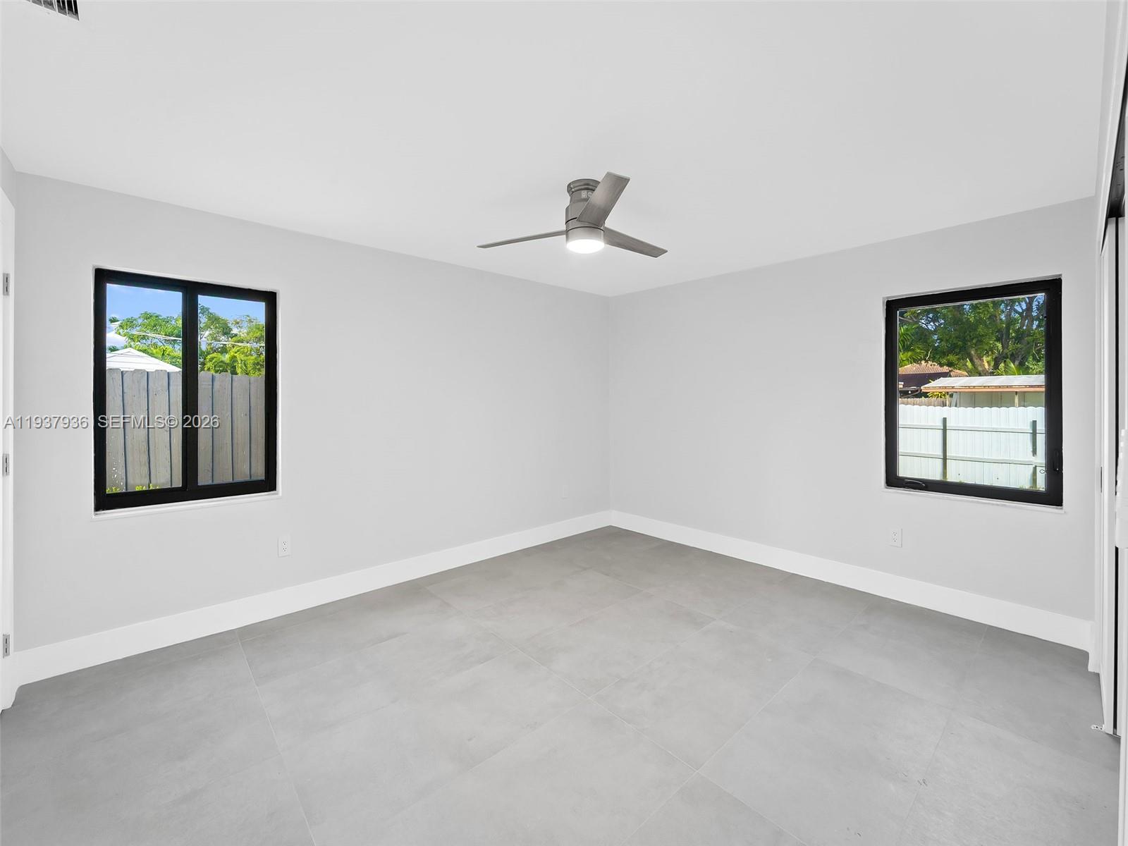 212 Southwest 7th Street Hallandale Beach, FL 33009 - Photo 11 of 23 an empty room with windows and closet