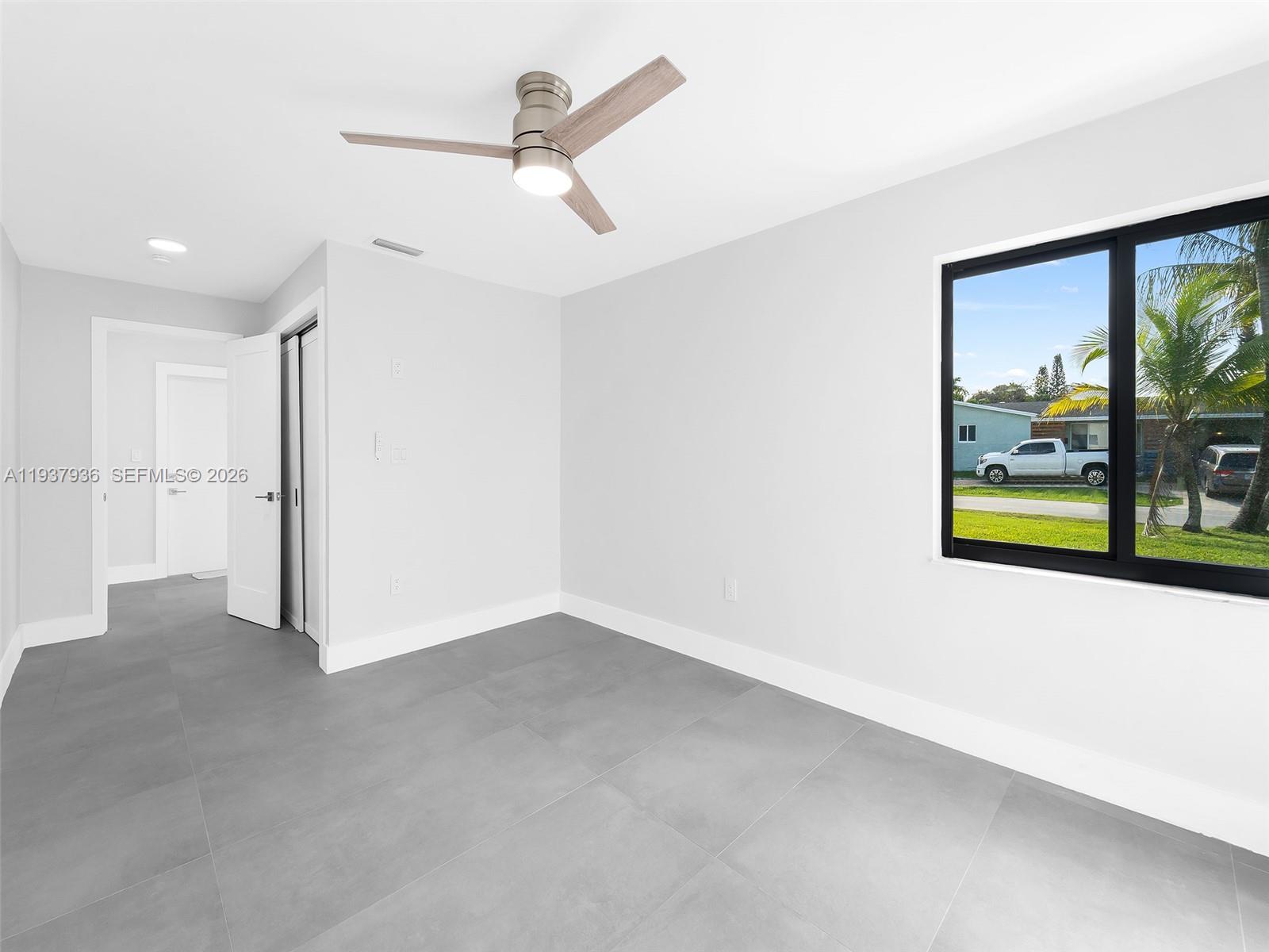 212 Southwest 7th Street Hallandale Beach, FL 33009 - Photo 15 of 23 a view of a livingroom with a ceiling fan and window
