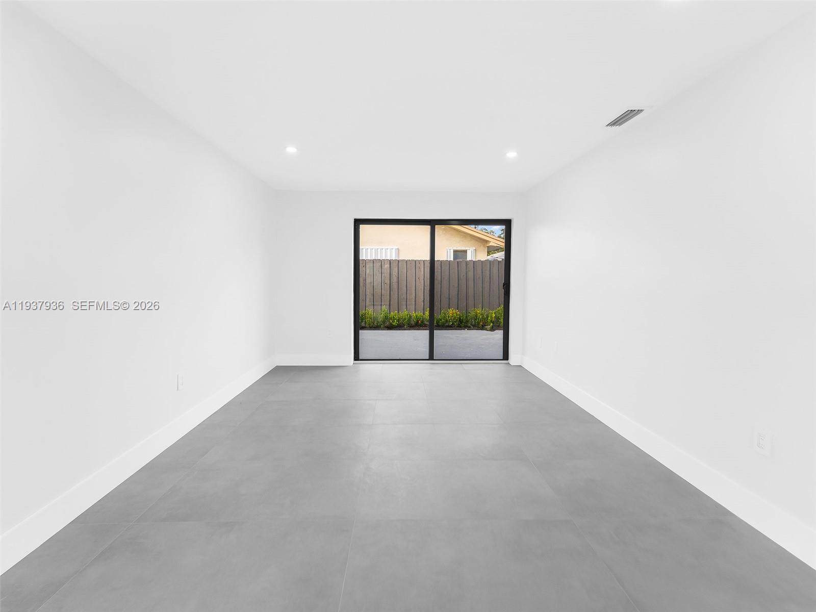 212 Southwest 7th Street Hallandale Beach, FL 33009 - Photo 17 of 23 a view of an empty room with a window