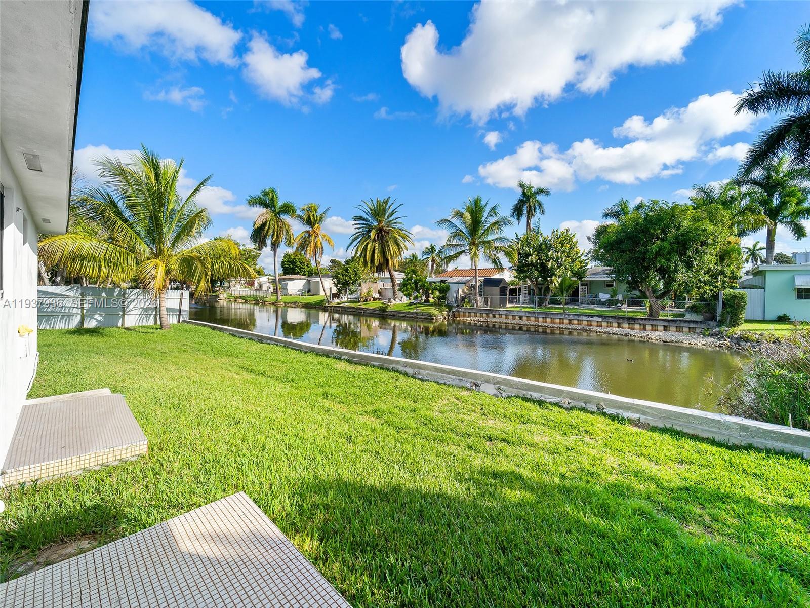 212 Southwest 7th Street Hallandale Beach, FL 33009 - Photo 18 of 23 a view of a lake with a garden