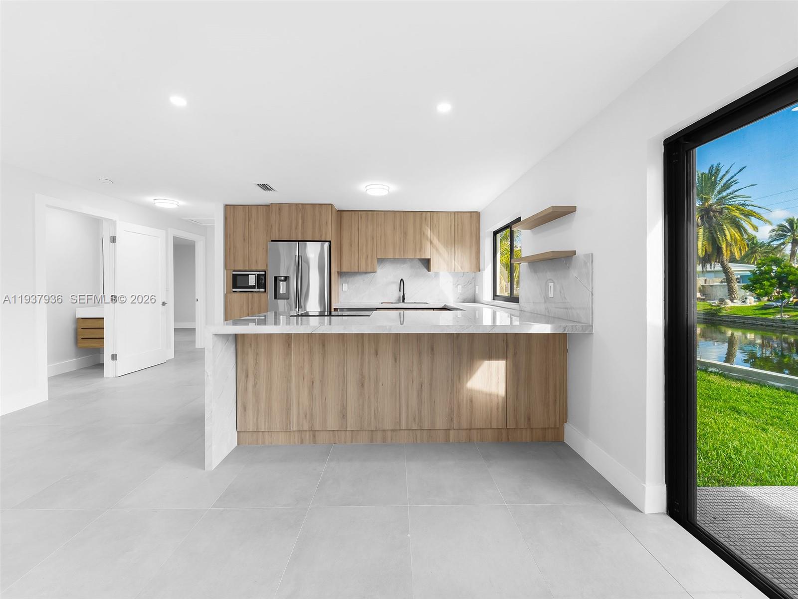 212 Southwest 7th Street Hallandale Beach, FL 33009 - Photo 2 of 23 a kitchen with granite countertop a white stove top oven a sink and a granite counter top