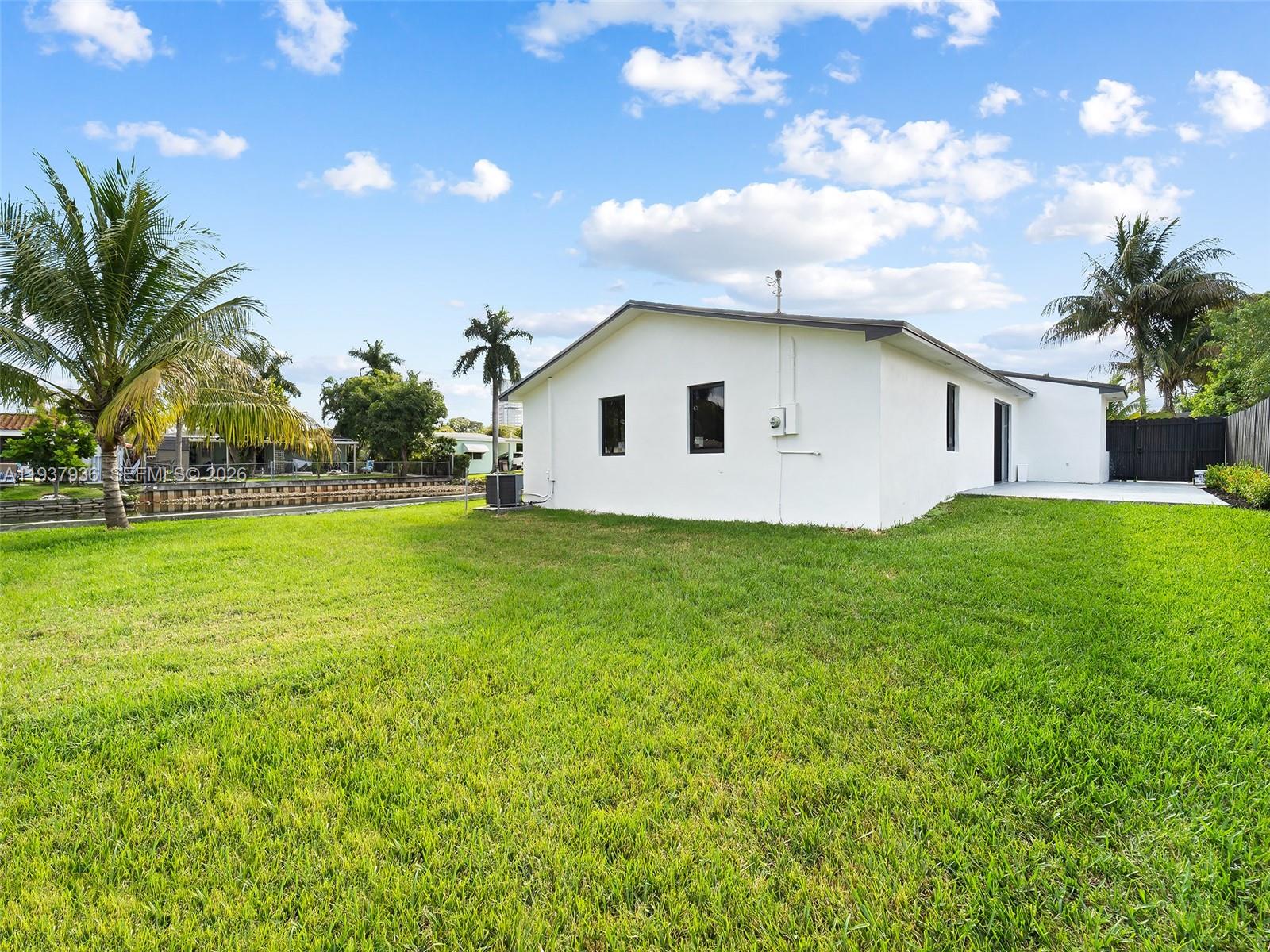 212 Southwest 7th Street Hallandale Beach, FL 33009 - Photo 22 of 23 a view of backyard of house with green space