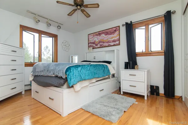 a bedroom with a bed and a painting on the wall