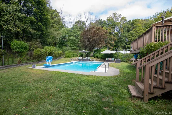 a view of a house with swimming pool and yard