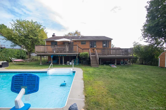 a view of a patio with table and chairs under an umbrella