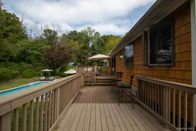 a view of a house with pool and trees