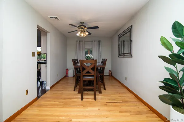 a dining room with furniture a rug and wooden floor