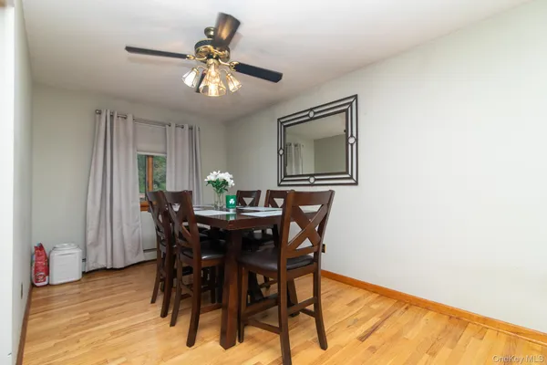a view of a dining room with furniture and chandelier