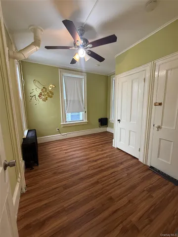 wooden floor in an empty room with a window