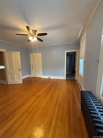a view of an empty room and wooden floor
