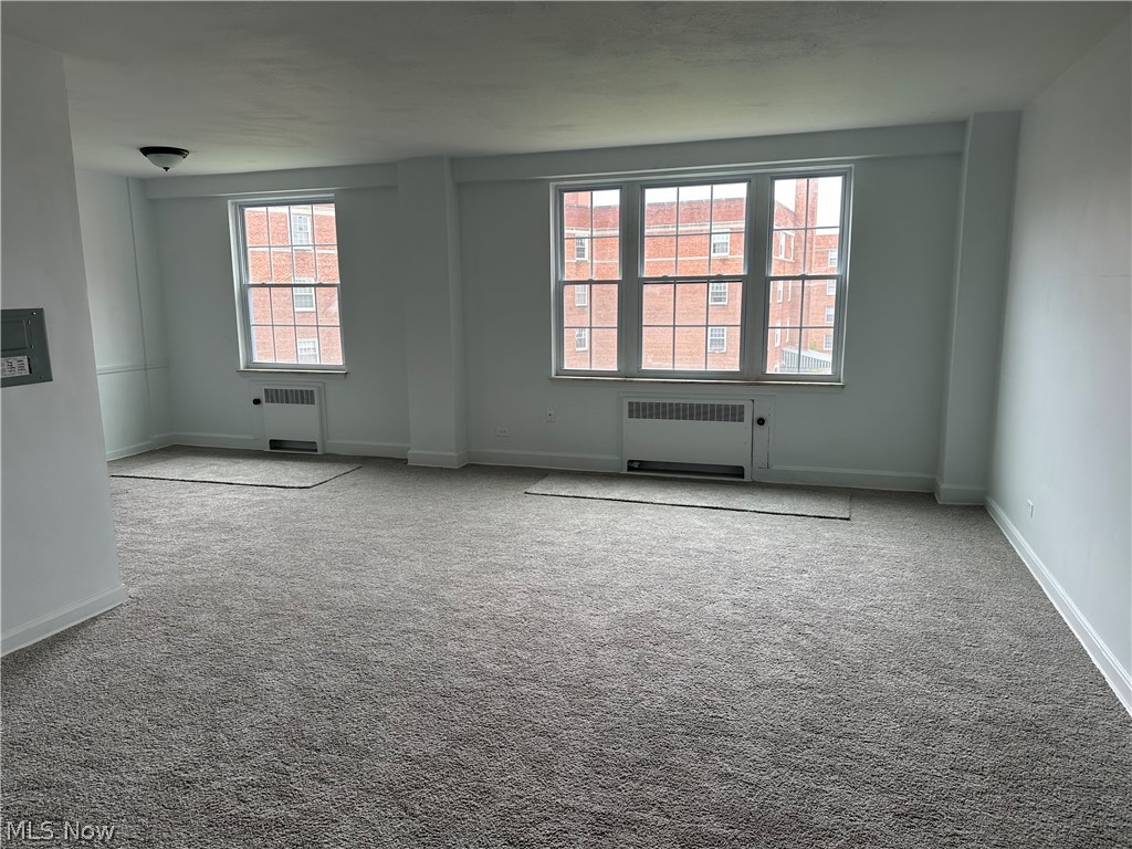 13800 Fairhill Road, Unit 416 Shaker Heights, OH 44120 - Photo 3 of 13 Spacious room featuring broad windows with grid panes, wall-to-wall carpeting, and baseboard trim