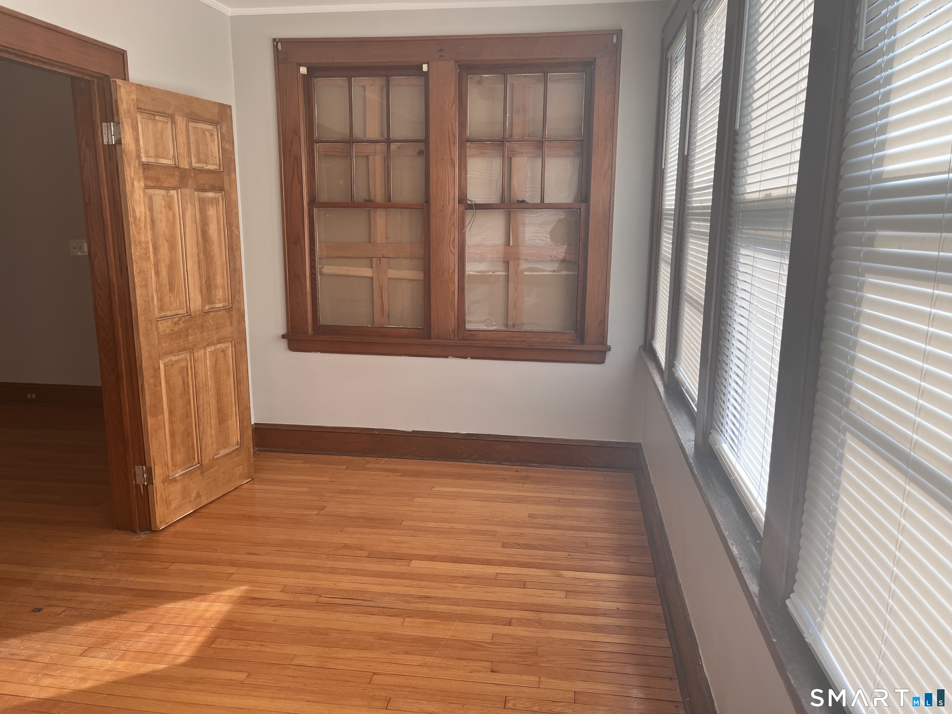 460 Anson Street Bridgeport, CT 06606 - Photo 12 of 24 a view of an empty room with wooden floor and a window