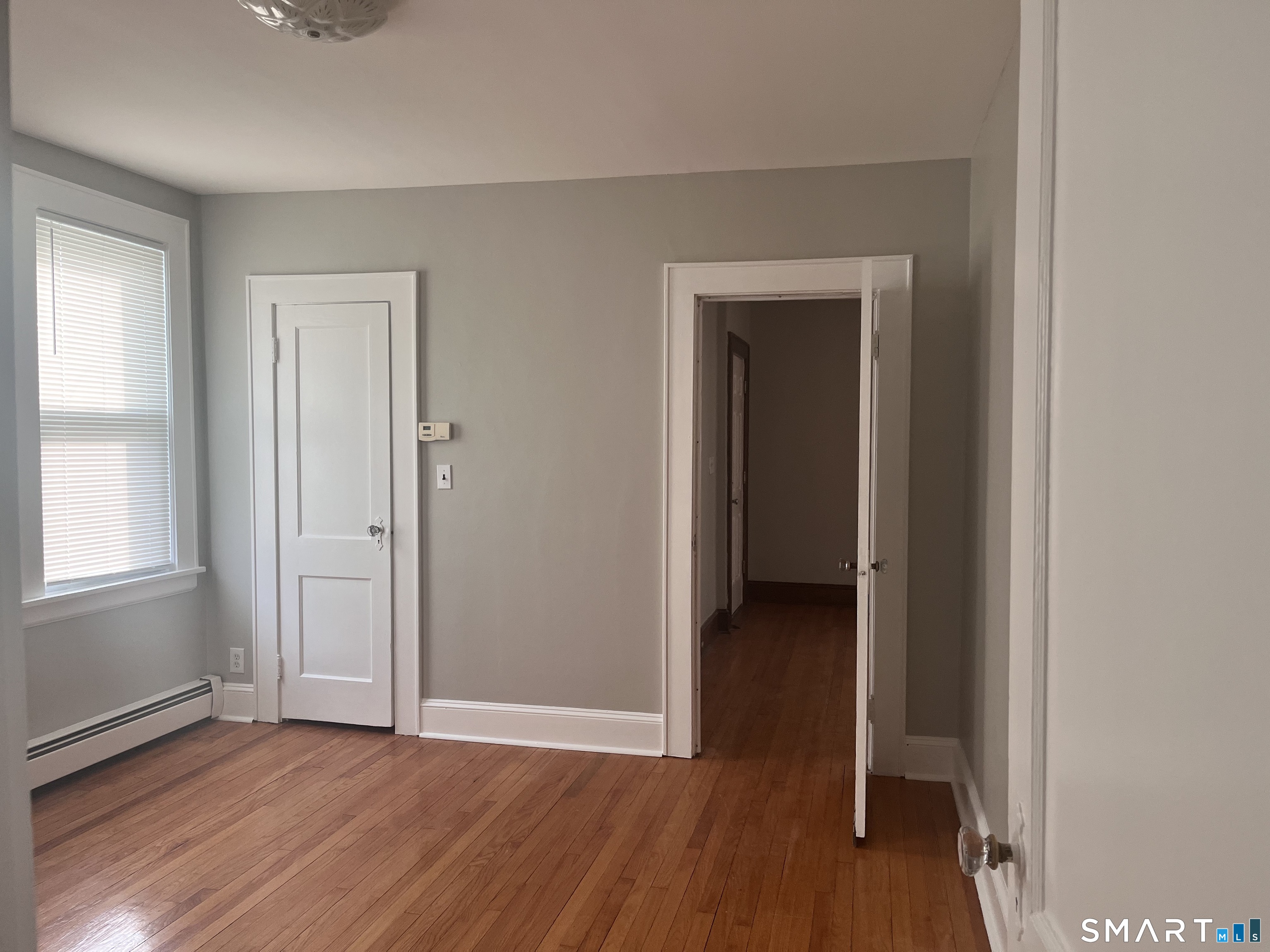 460 Anson Street Bridgeport, CT 06606 - Photo 14 of 24 an empty room with wooden floor and closet