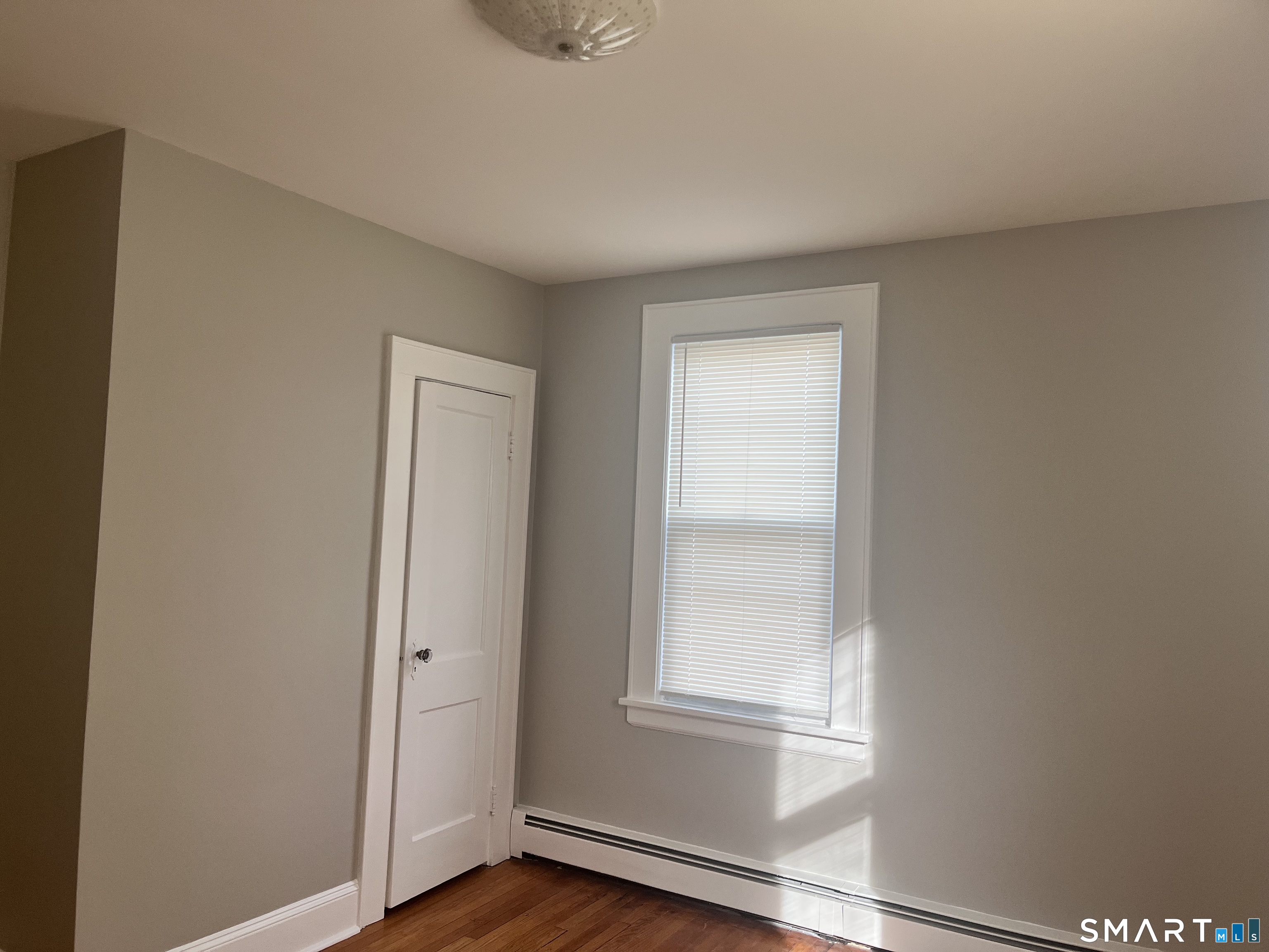 460 Anson Street Bridgeport, CT 06606 - Photo 16 of 24 a view of an empty room with wooden floor and a window