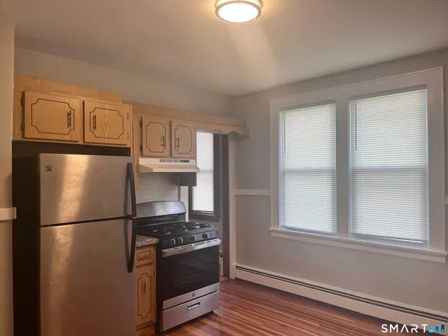 a kitchen with stainless steel appliances granite countertop a refrigerator sink and cabinets