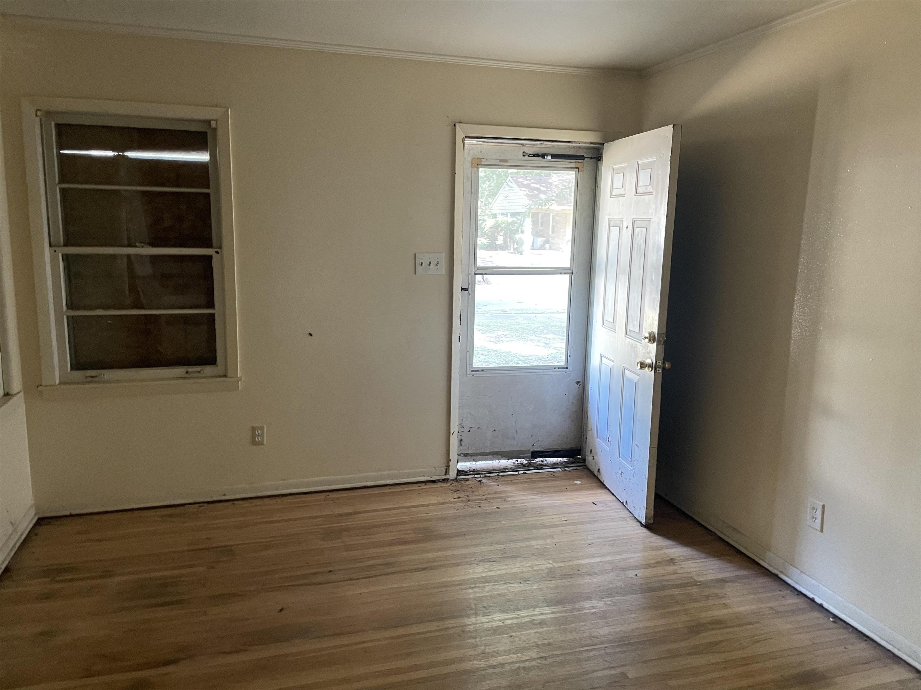 1511 Welsh Road Memphis, TN 38117 - Photo 2 of 7 an empty room with wooden floor and windows