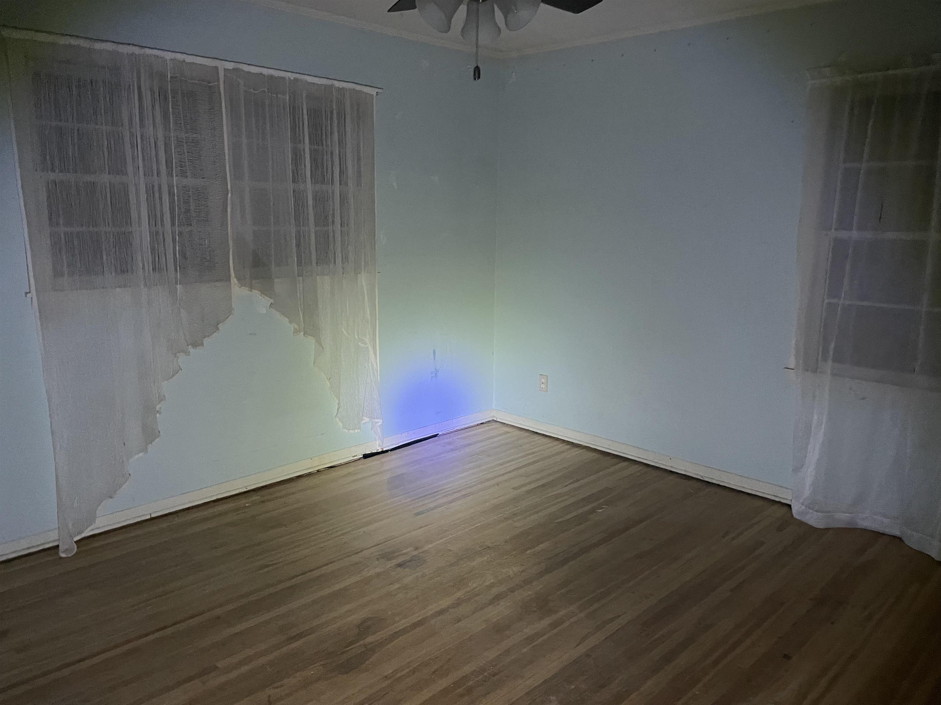1511 Welsh Road Memphis, TN 38117 - Photo 5 of 7 a view of an empty room with wooden floor and a window