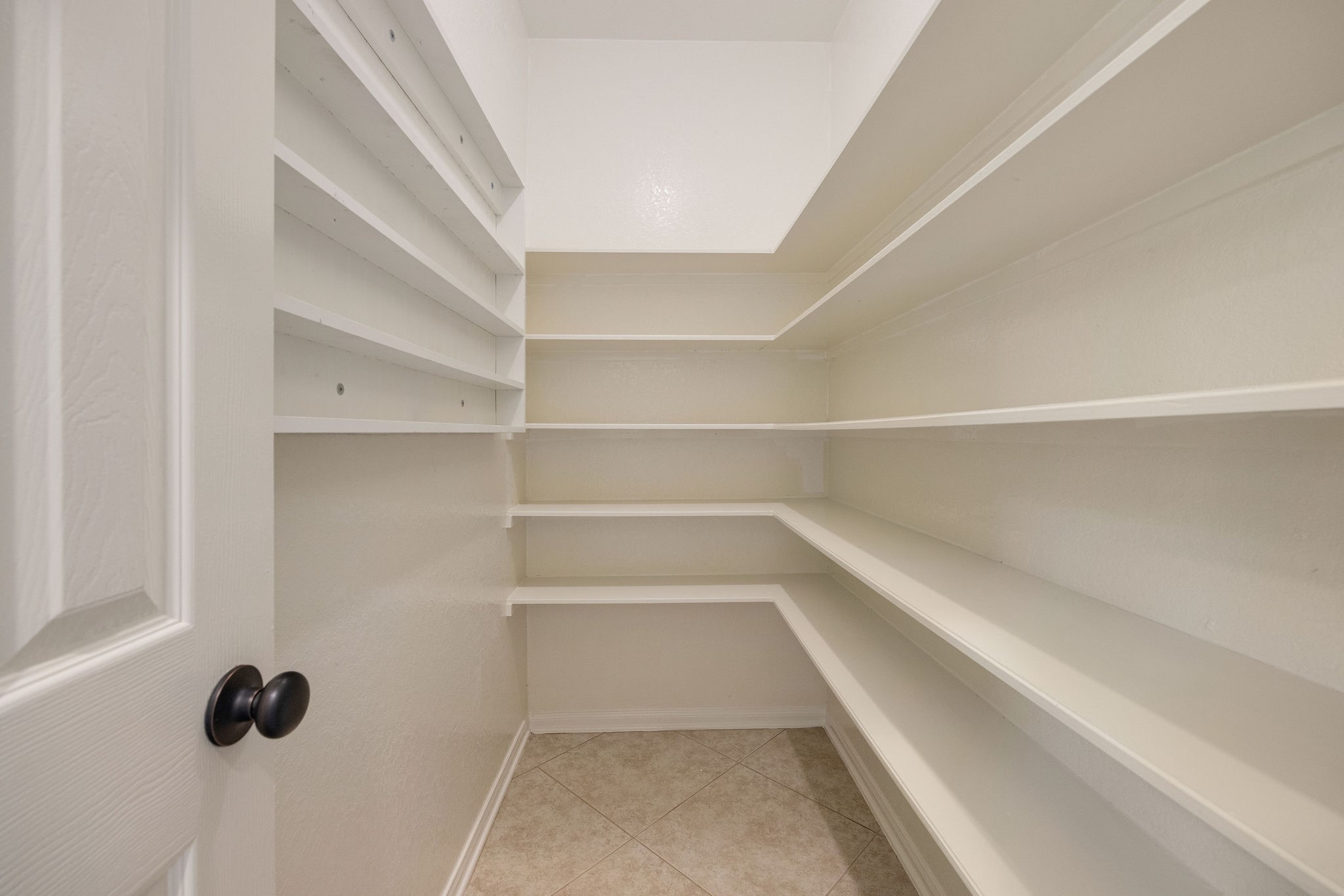 9603 Randon Lane Missouri City, TX 77459 - Photo 24 of 50 Space abounds in this amazing newly painted walk-in pantry.