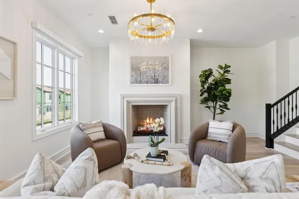 a living room with furniture and a chandelier