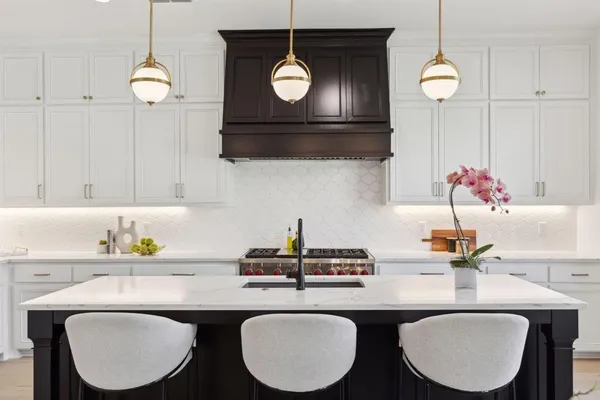 a kitchen with a table a sink and cabinets