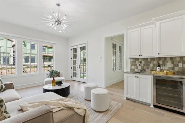 a living room with furniture and a chandelier
