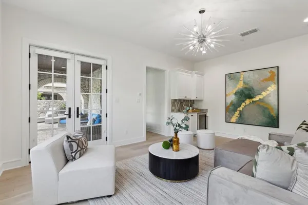 a view of living room and patio with swimming pool