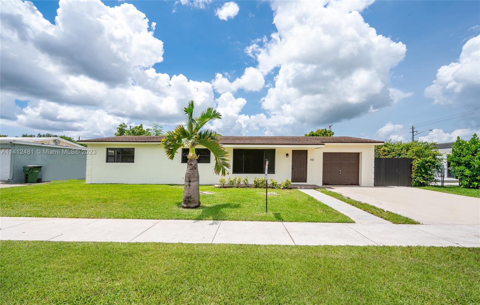 532 Northwest 15th Street Homestead, FL 33030 - Photo 1 of 32 a front view of a house with a yard and garage